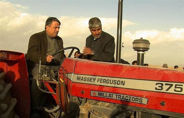 Kandahar governor Tooryalai Weesa drives a tractor to destroy poppy fields