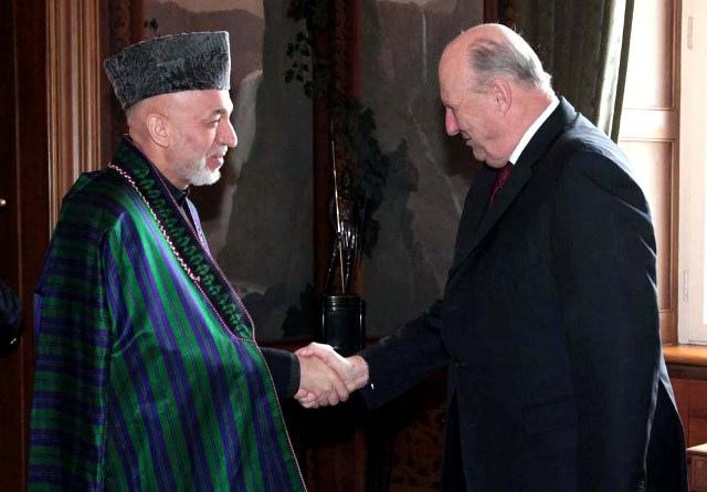 President Hamid Karzai shakes hands with Norwegian King