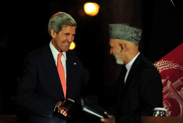 Hamid Karzai shakes hands with US Secretary of State