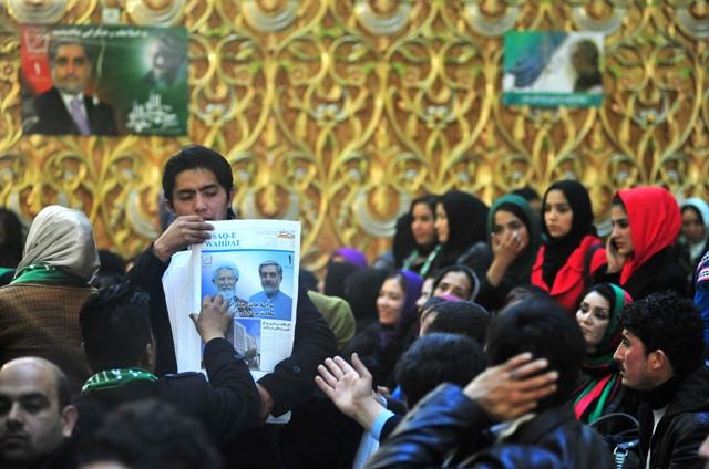 A supporter of Dr. Abdullah Abdullah distributes news papers