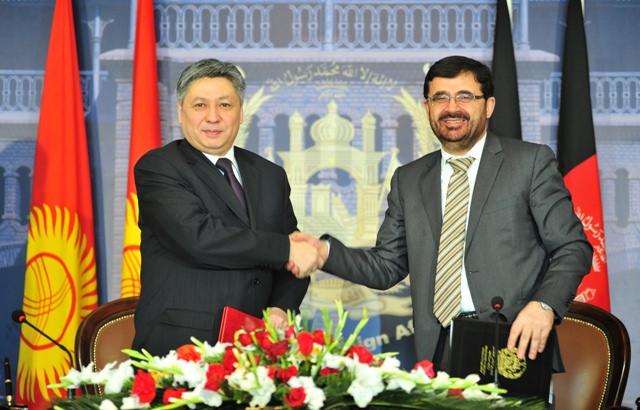Afghan foreign affairs Minister shakes hands with his Kyrgyz counterpart