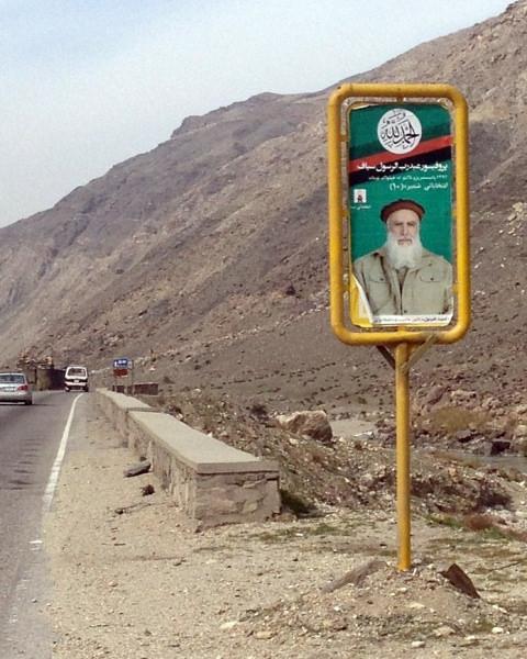 Poster of Abdul Rab Rasoul Sayyaf on a roadside signboard