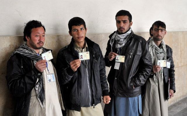 Men show their voting cards