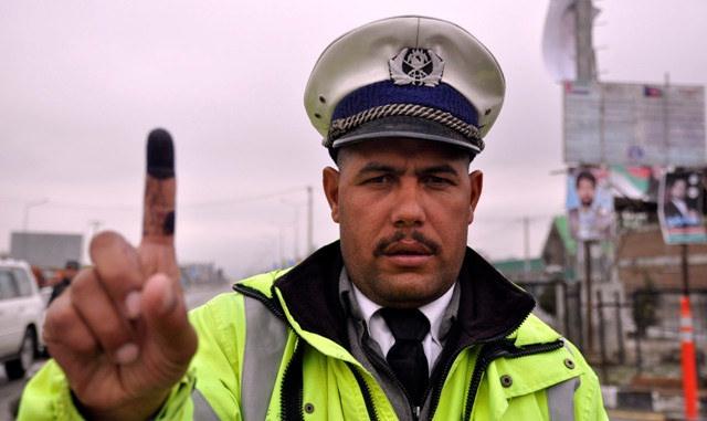 A traffic officer shows his coloured finger