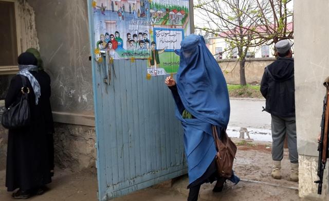 A woman goes to a polling centre