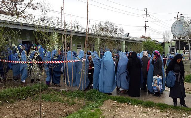 Women queue up outside of a polling centre