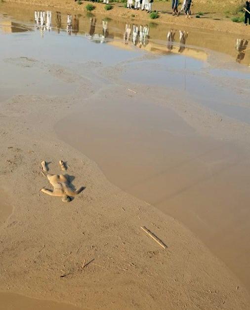 Body of a man is stuck in mud after the devastated floods