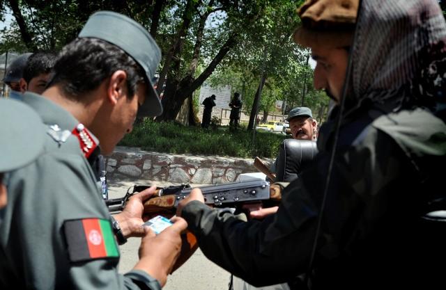 A policeman check license of a machine-gun