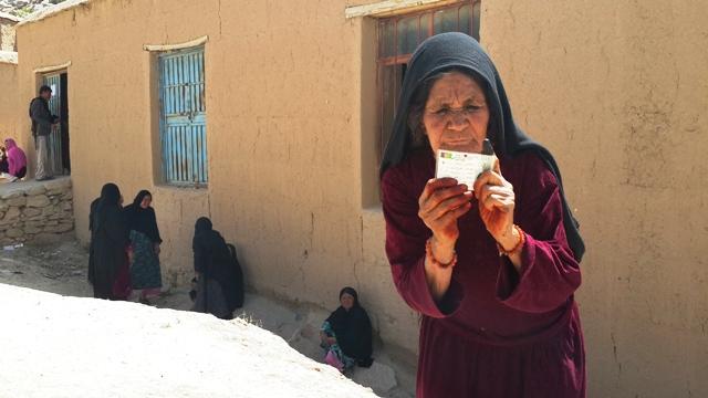Elderly woman votes for a better tomorrow