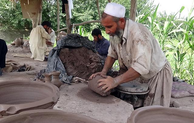 A potter makes clay pot