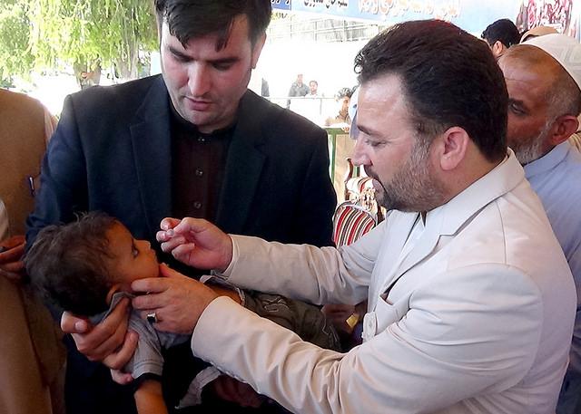 Official administers polio vaccine