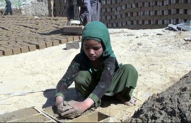 10-year-old Zakia laying bricks