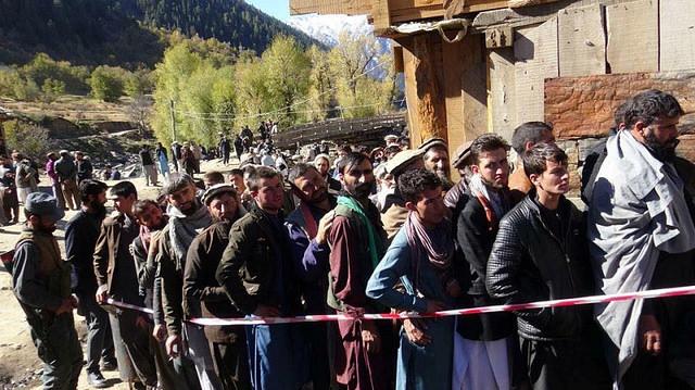 Nooristan people wait in a queue for vote