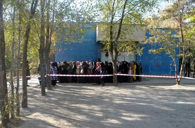 Women wait in a queue for vote