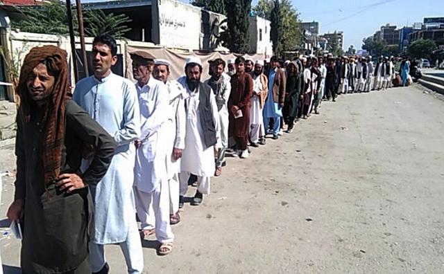 Khost people wait in a queue for casting vote