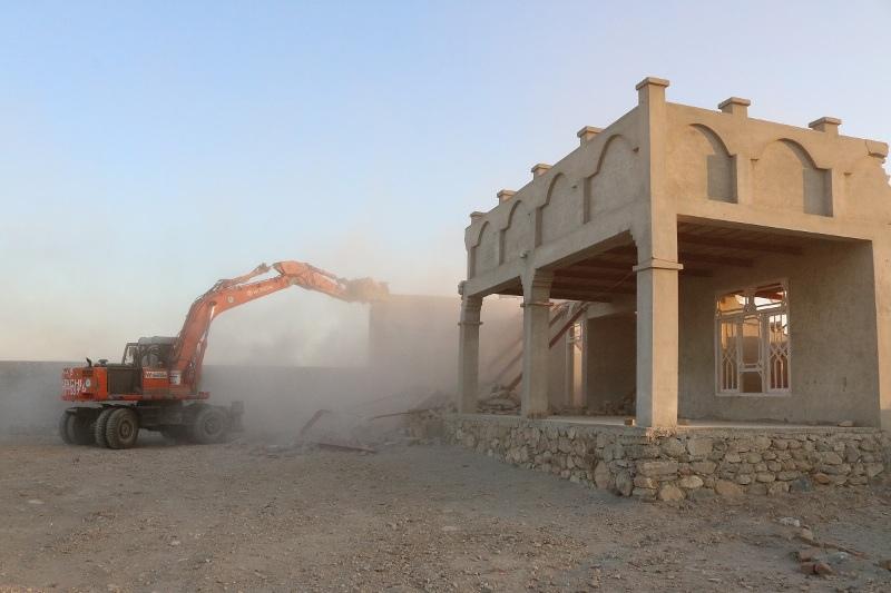 Grabbed land: house being destroyed