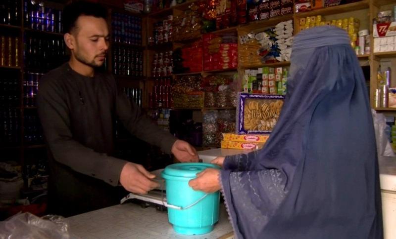 A woman delivers dairy to shopkeeper
