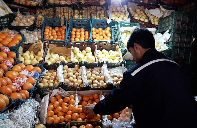 Man buys fruit from shop