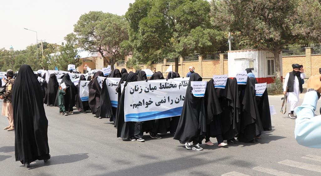 Carrying Taliban flags, female students rally for rights