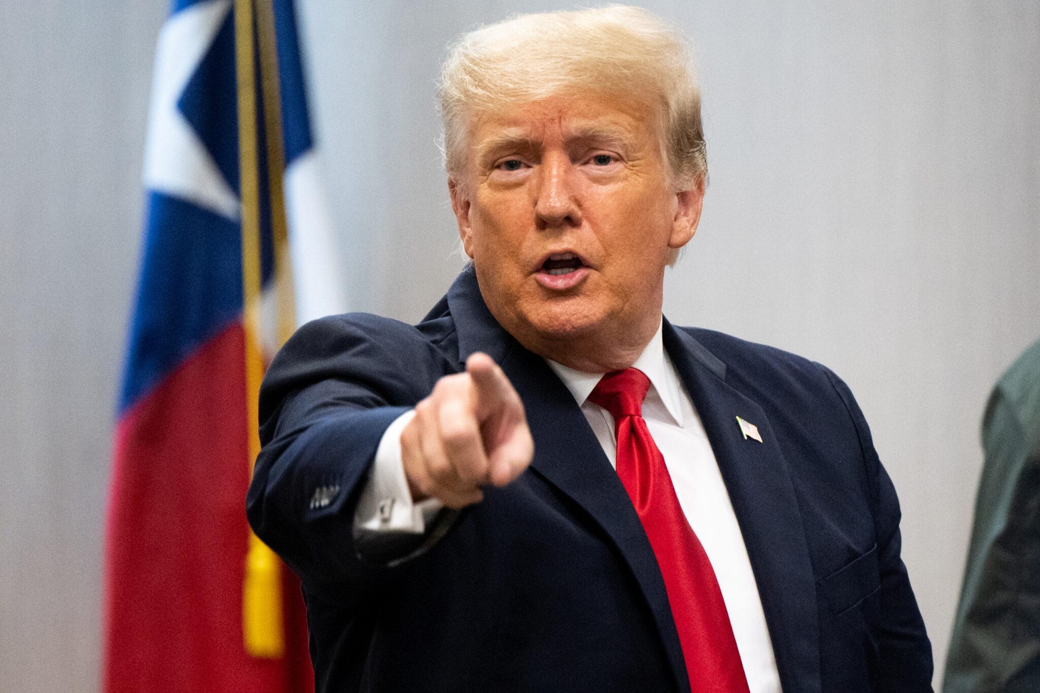 Former U.S. President Donald Trump addresses a member of the news media after attending a border security briefing with Texas Governor Greg Abbott to discuss security at the U.S. southern border with Mexico in Weslaco, Texas, U.S. June 30, 2021.